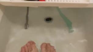 skinny twig strokes his cock and pissed in sink and shows off feet in bathtub